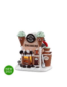 a christmas ornament with an ice cream shop in the front and two cones on top