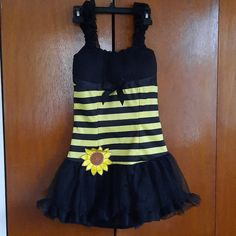 a black and yellow striped dress with a sunflower on the front, attached to a door