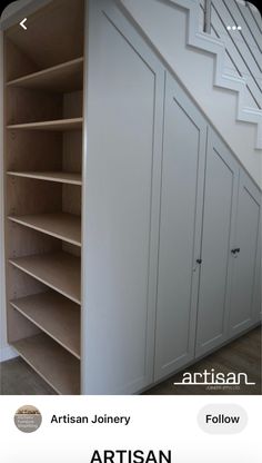 an image of a book shelf under stairs