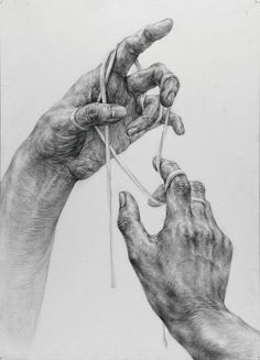 two hands are knitting together on a white paper with black and white drawing in the background