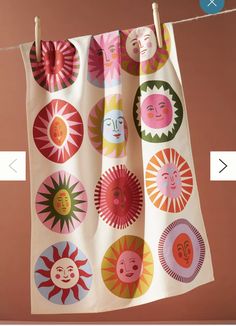 the sun and moon designs are hanging from a clothes line