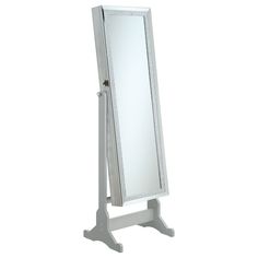 a white standing mirror on top of a wooden stand