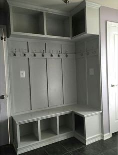 a room with some white cabinets and benches