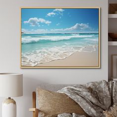 a beach scene with waves crashing on the shore and blue sky above it, framed in gold frame