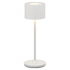 a white table lamp with a light on it