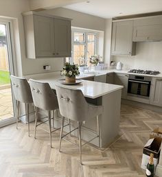 a kitchen filled with lots of counter top space next to a wooden floored floor