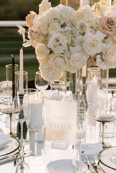 a table set with flowers and candles for a formal dinner or wedding reception at the four seasons resort