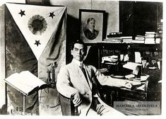 an old black and white photo of a man in his office