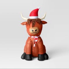 an inflatable cow with a santa hat on it's head and legs