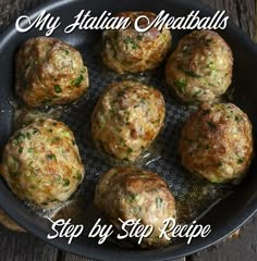 a pan filled with meatballs sitting on top of a wooden table