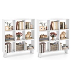 two white bookcases filled with books and vases on top of each other