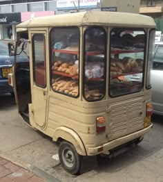 a small cart with bread and pastries on the back