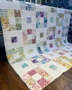 a large quilt is sitting on the floor