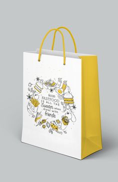 a white shopping bag with yellow handles and an image of food on the front that says,