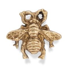 a gold bee brooch with two eyes on it's back and one eye open