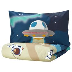 two pillow cases with cartoon characters on them and one has an alien ship in the sky