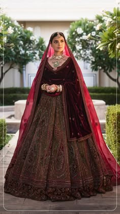 a woman in a red and gold wedding dress