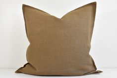 a brown pillow sitting on top of a white table