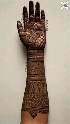 a woman's hand with hendi on it, showing the intricate pattern and design