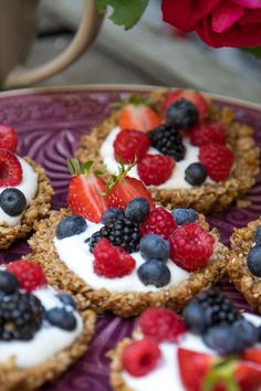 small desserts with berries, strawberries, and blueberries on a purple plate