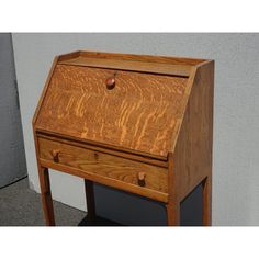 an old wooden desk with drawers on the bottom and one drawer at the top that has been turned upside down