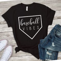 a t - shirt that says baseball vibes on it next to jeans and sneakers