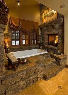 a large bathroom with a fireplace and stone bathtub