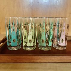 six glasses sitting on top of a wooden tray