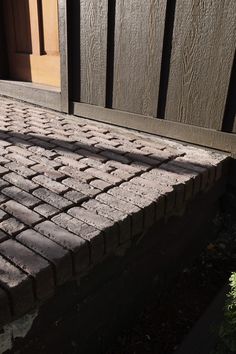 a brick bench sitting in front of a door