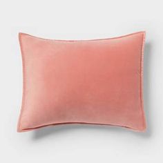 a pink pillow on a white background