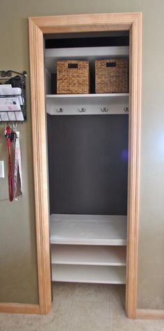 an empty closet with two baskets on the shelves