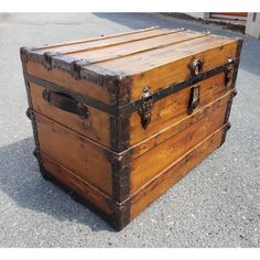 an old wooden trunk sitting on the ground