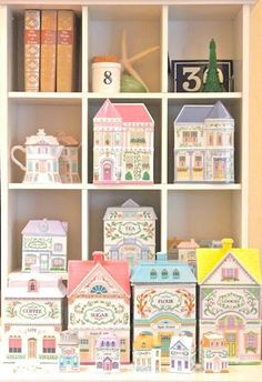 a book shelf filled with lots of little houses