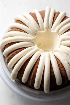 a bundt cake with white icing on a plate