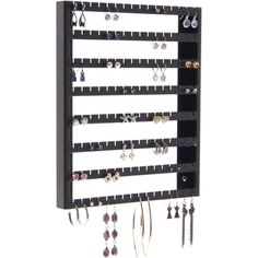 a wall mounted jewelry rack with several pairs of earrings