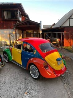 a multicolored car parked in front of a house