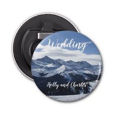 a button with the words, wedding and mountains in white lettering on blue sky background