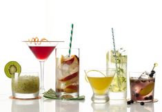 several different types of cocktails lined up on a table