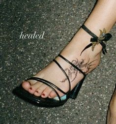 a woman's foot with a tattoo on it