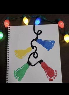 an art project with colored handprints and string lights