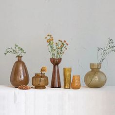 there are many vases on the table together