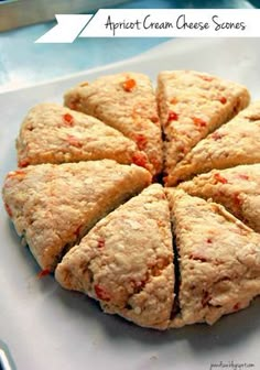 a white plate topped with sliced up scones on top of a blue table cloth