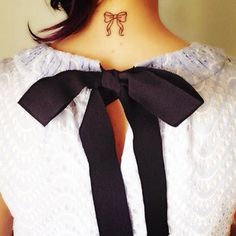 a woman with a bow tattoo on her neck is shown in an instagramture