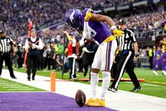 a football player standing on top of a field