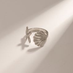 Embrace the spirit of summer with our Adjustable Stainless Steel Bohemian Beach Ring. Crafted to capture the essence of beachside freedom and boho chic, this ring features a unique, irregular design adorned with starfish and shell motifs. Perfect for beach parties, vacations, or just adding a touch of seaside magic to your everyday wear, this ring brings the ocean’s charm right to your fingertips. Product Features The Bohemian Beach Ring is designed with versatility and durability in mind. Its a Wedding Ban, Beach Rings, Wedding Band Styles, Men Shoes Formal, Beach Parties, Bohemian Beach, Sunny Beach, The Bohemian, Steel Design