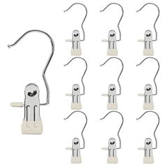 twelve pairs of hooks and clips on a white background