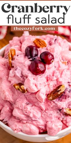 cranberry fluff salad in a white bowl with pecans and cherries