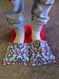 the legs of a person standing on top of a rug