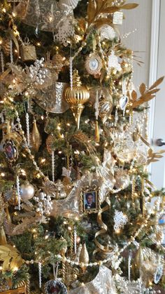 a christmas tree decorated with gold and silver ornaments