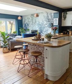 a kitchen island with two stools next to it